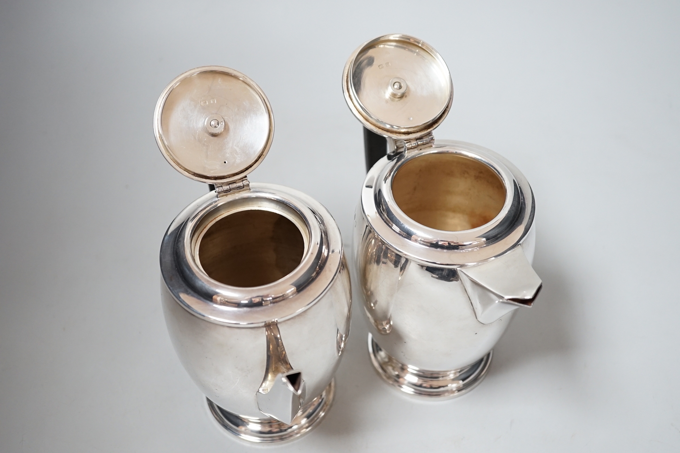 A George V silver cafe au lait pair by Hukin & Heath, Birmingham, 1934, height 15.8cm, gross weight 27.6oz.